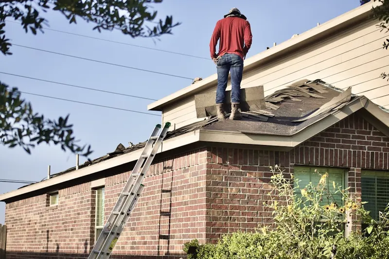 Professional roofer working on a residential roof in Westville